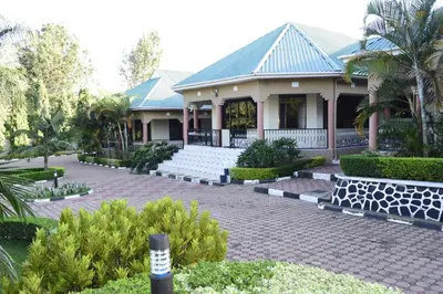 a house with a cobblestone driveway in front of it at Africa Lodge Arusha in Nkoaranga
