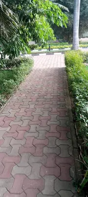 a brick path in the middle of a park at Africa Lodge Arusha in Nkoaranga