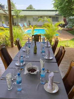 a long table with plates and bottles of water on it at Karanga River Lodge in Moshi