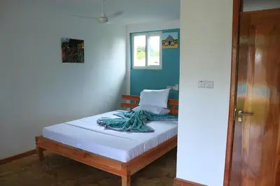 a bedroom with a bed and a window at Karanga River Lodge in Moshi