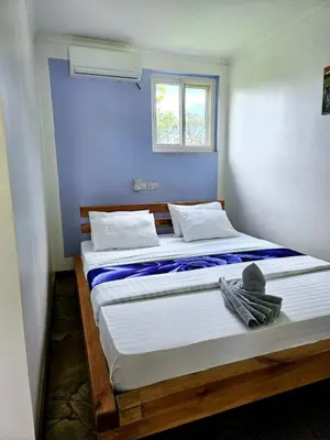 a bedroom with a large bed with a window at Karanga River Lodge in Moshi