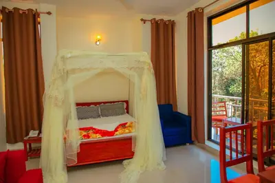 a bedroom with a bed with a canopy at Kilimanjaro White House Hotel in Moshi