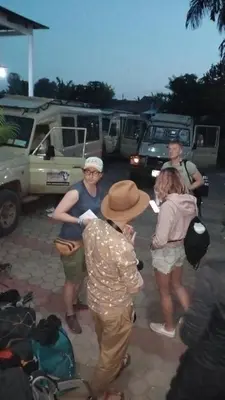 a group of people standing around in a parking lot at New Charity Hotel International in Arusha