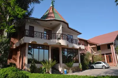 a house with a tower on top of it at New Charity Hotel International in Arusha