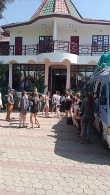 a group of people walking in front of a building at New Charity Hotel International in Arusha