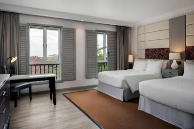 a hotel room with two beds and a desk and windows at Four Points by Sheraton Arusha, The Arusha Hotel in Arusha