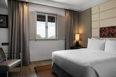 a hotel room with a bed and a window at Four Points by Sheraton Arusha, The Arusha Hotel in Arusha