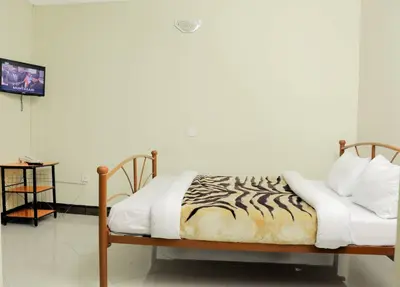 a bed with a zebra printed comforter in a room at Maresi Luxury Hotel in Arusha