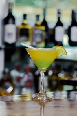 a yellow drink in a martini glass with a lemon wedge at Maresi Luxury Hotel in Arusha