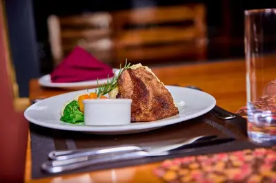 a plate of food sitting on a table at Shamba Lodge Cabin B in Arusha