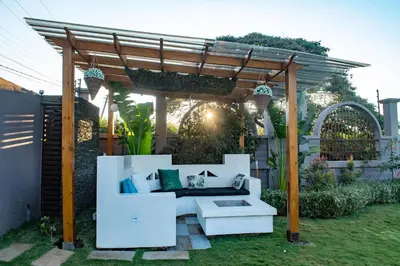 a pergola with a white couch in a yard at Kinga Homes Boutique Hotel in Moshi