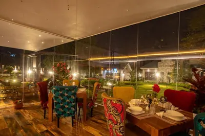 a restaurant with a table and chairs in a room at Kinga Homes Boutique Hotel in Moshi