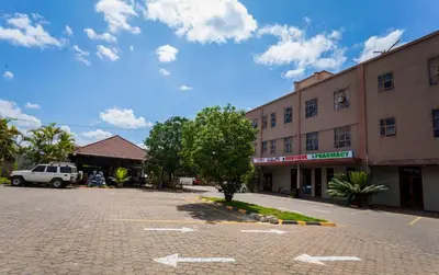 an empty parking lot in front of a building at Panone Hotels - King'ori Kilimanjaro Airport in Moshi