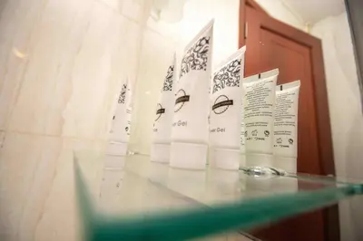 a glass table with a display of eyes on paper at Panone Hotels - King'ori Kilimanjaro Airport in Moshi