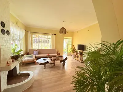 a living room with a couch and a table at Nguruma house of travellers and tours in Arusha