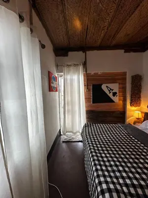 a bedroom with a bed in a room with a window at Nguruma house of travellers and tours in Arusha