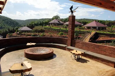 a patio with a statue of a woman on top of a vineyard at Ngorongoro Marera Mountain View Lodge in Karatu