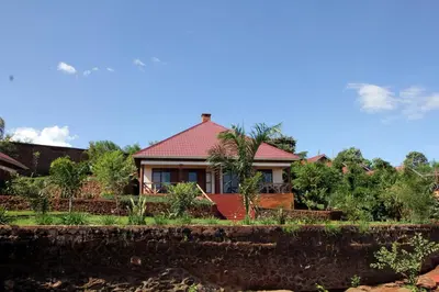 a house with a red roof and a yard at Ngorongoro Marera Mountain View Lodge in Karatu