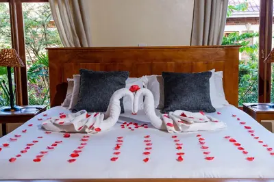 a bed with two swans made out of hearts at Ngorongoro Marera Mountain View Lodge in Karatu