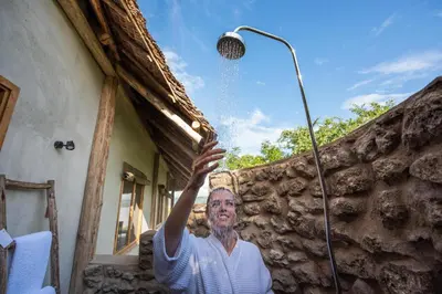 an older man is standing next to a street light at Manyara's Secret in Mto wa Mbu