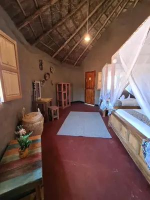 a living room with a bed and a rug at Africa Safari Maasai Boma in Serengeti