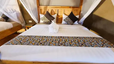 a couple of beds in a room at Africa Safari Maasai Boma in Serengeti