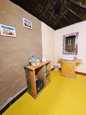 a room with a table and a yellow floor at Africa Safari Maasai Boma in Serengeti