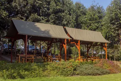 a pavilion with a covering on it in a park at Shamba Lodge Cabin C in Olmotoni