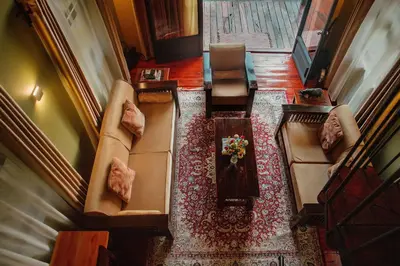 an overhead view of a living room with couches and a table at Shamba Lodge Cabin C in Olmotoni