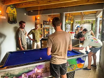 a group of men standing around a pool table at Home Villa Eco Boutique in Arusha