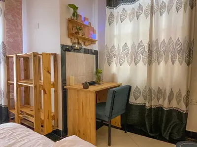 a room with a desk and a curtain at Home Villa Eco Boutique in Arusha