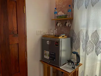 a microwave sitting on a table in a room at Home Villa Eco Boutique in Arusha
