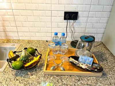 a tray with glasses and bottles of water on a counter at Home Villa Eco Boutique in Arusha