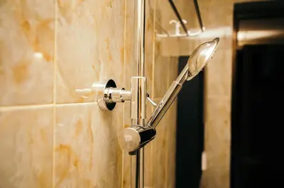 a shower head on a wall in a bathroom at Dual Mountain View Lodge in Moshi