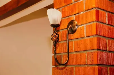 a light on the side of a brick wall at Dual Mountain View Lodge in Moshi