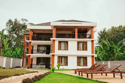 a building with two benches in front of it at Dual Mountain View Lodge in Moshi