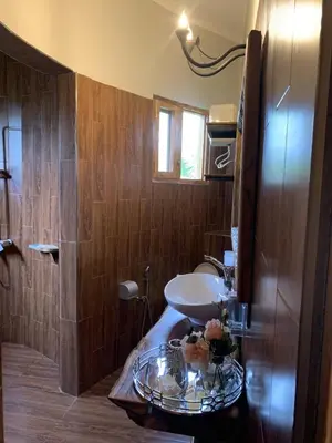 a bathroom with a sink and a glass table at Tulivu Kilimanjaro Retreat in Msaranga