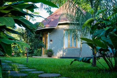a house with a pathway in front of a yard at Tulivu Kilimanjaro Retreat in Msaranga