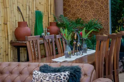 a table with a couch and a table with plants at Tulivu Kilimanjaro Retreat in Msaranga