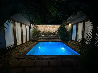 a swimming pool in the middle of a yard at night at Tulivu Kilimanjaro Retreat in Msaranga
