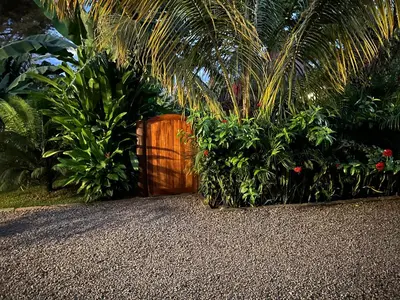 a wooden gate in a garden with plants at Tulivu Kilimanjaro Retreat in Msaranga
