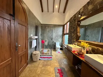 a bathroom with a shower and a sink at Tulivu Kilimanjaro Retreat in Msaranga