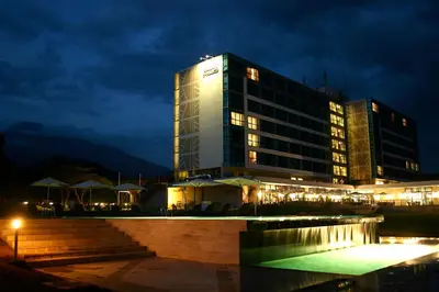 a tall building with lights in front of it at night at Mount Meru Hotel in Arusha