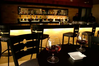 two glasses of wine sitting on a table in a restaurant at Mount Meru Hotel in Arusha