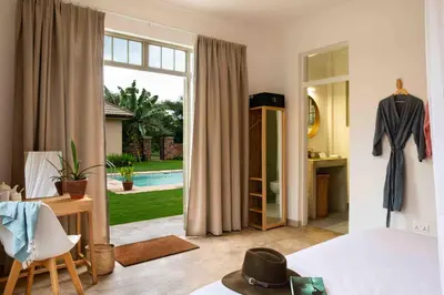 a bedroom with a bed and a sliding glass door at The Safari House in Usa River