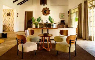 a living room with a table and chairs at The Safari House in Usa River