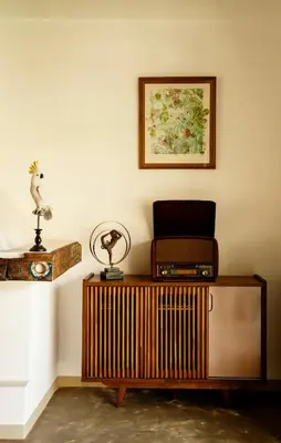 a room with a wooden cabinet and a picture on the wall at The Safari House in Usa River