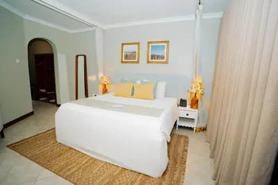 a bedroom with a large white bed in a room at Arusha Planet Lodge in Arusha