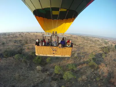 a group of people riding a hot air balloon at Elephant Rock Luxury Camp Tarangire in Kaiti