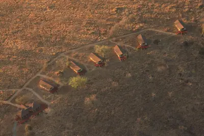 an overhead view of a group of trucks in a field at Elephant Rock Luxury Camp Tarangire in Kaiti